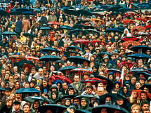Zuschauer und Regenschirme - Wandbild